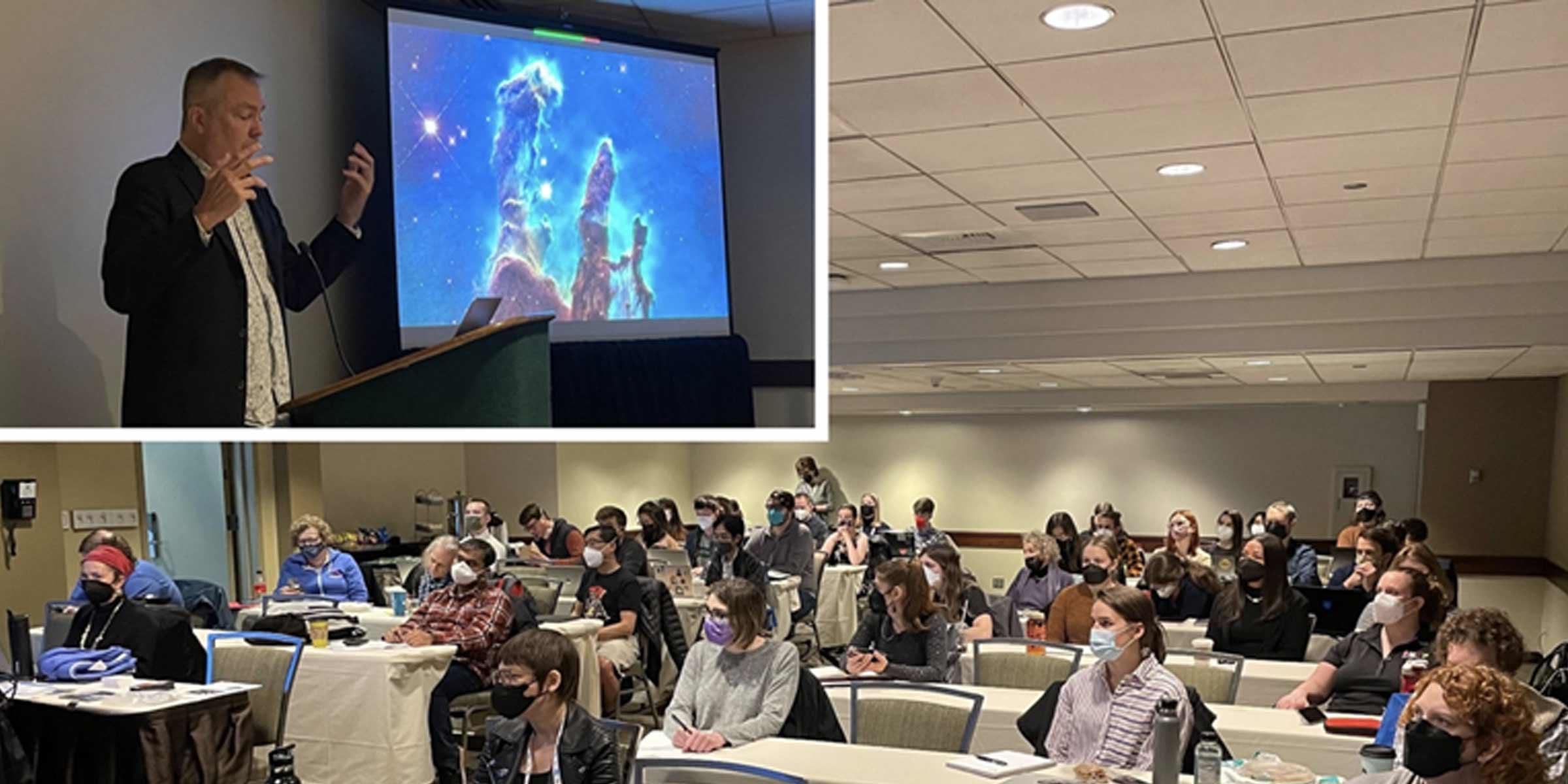 At top left, a speaker with his hands raised stands in front of a podium with a microphone. The Pillars of Creation, which look like three dusty fingers rising from the bottom of the screen, are shown at his right on a large screen. The remainder of the image shows long tables set up horizontally with several people seated at each, all masked.
