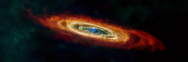 An artificial color image showing a ring or spiral-like structure at a large inclination angle, with red colored spirals at the outer radii depicting hydrogen gas emission, yellowish- green spirals inside the red spirals indicating cold dust emission, and finally blue spirals around the center of the image revealing hot dust emission. Credit: ESA/NASA/JPL-Caltech/GBT/WSRT/IRAM/C. Clark (STScI)