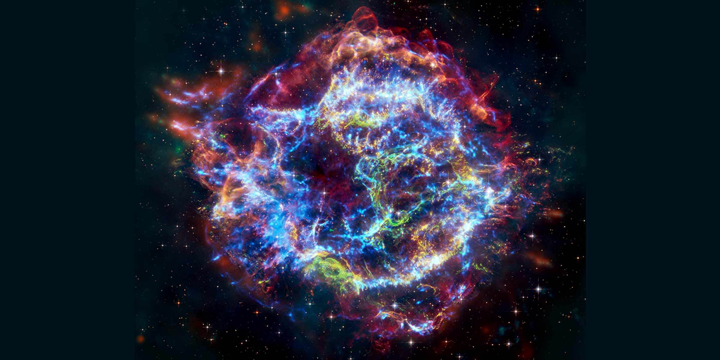 Supernova remnant Cassiopeia A imaged by the Chandra X-ray Observatory and the James Webb Space Telescope. Cassiopeia A is a roughly circular cloud of multicolored gas against a black background. The colors range from blue and purple to pink and yellow, resembling a cosmic smoke ring. The outside of the remnant appears as a mottled blue ring. Inside of the blue ring is another wide ring, made of a series of dense filaments in shades of pink, white, and orange. The center of the remnant is dominated by a network of blue filaments. There is a bright white point near the center.