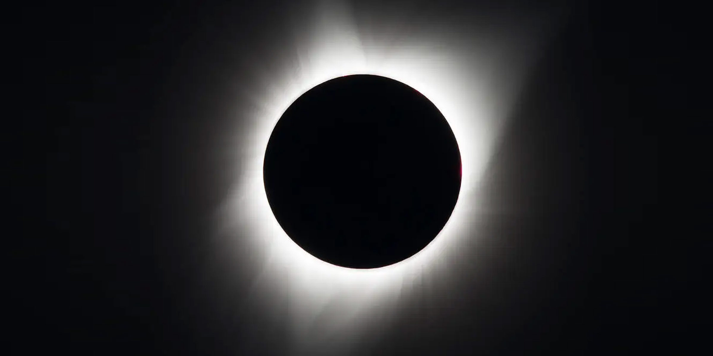 Total Solar Eclipse Illustration depicted by bright white flares surrounding a black circular object
