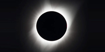 Total Solar Eclipse Illustration depicted by bright white flares surrounding a black circular object.