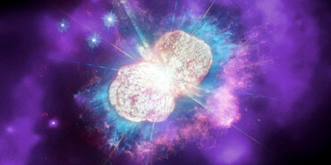 Eta Carinae, an hourglass-shaped nebula, angled so that one lobe is closer than the other. In the background, is a diffuse blue and pink glow.