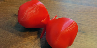 An hourglass-shaped 3D printed structure resembling Eta Carinae sitting on a wood tabletop.
