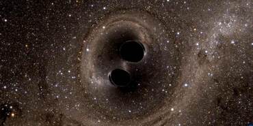 Artist’s concept of two black holes merging. Many points of light are scattered across the black background of space. Two black holes are diagonal from each other in the center. Toward the center, the region near the two black holes is warped.