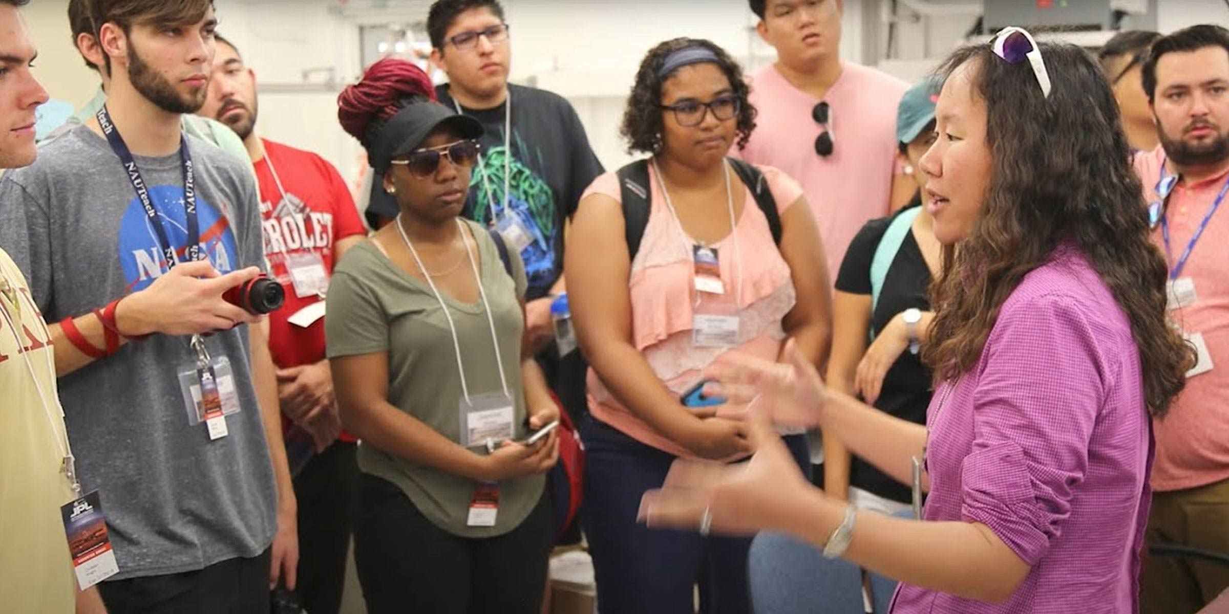 Woman speaks in front of a small group of people