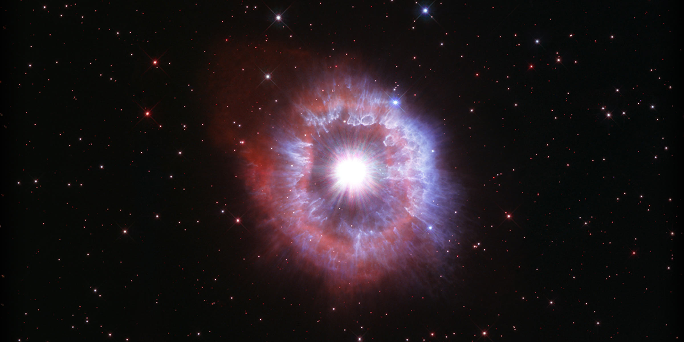 Bright star surrounded by shell of gas and dust
