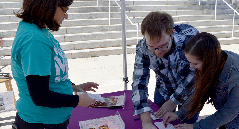 People engaged in an art activity at a table