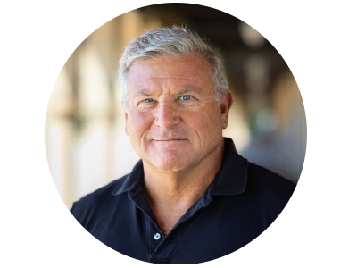 A man wearing a black shirt looks at the camera.